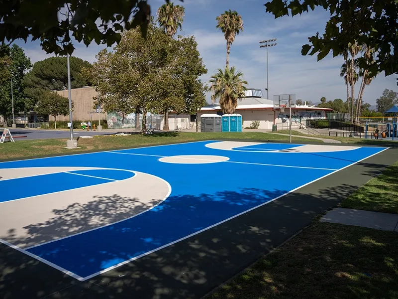 StreetBond installation: outdoor basketball court coated in blue reflective pavement coating
