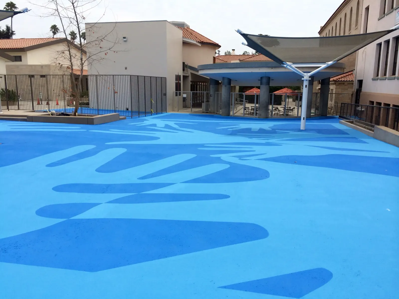StreetBond installation: schoolyard pavement coated in two shades of blue